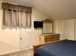 Upstairs bedroom offers king bed and bureau